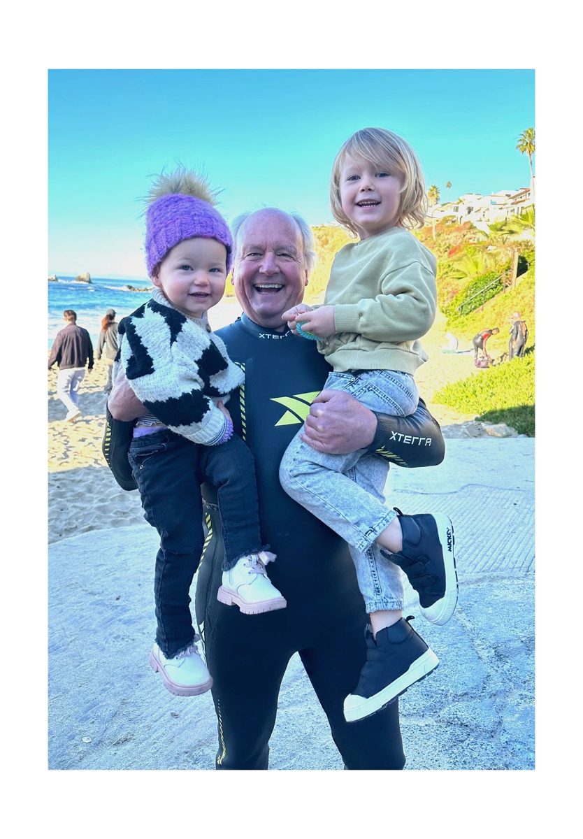 Leith Swanson on the beach with his granddaughters