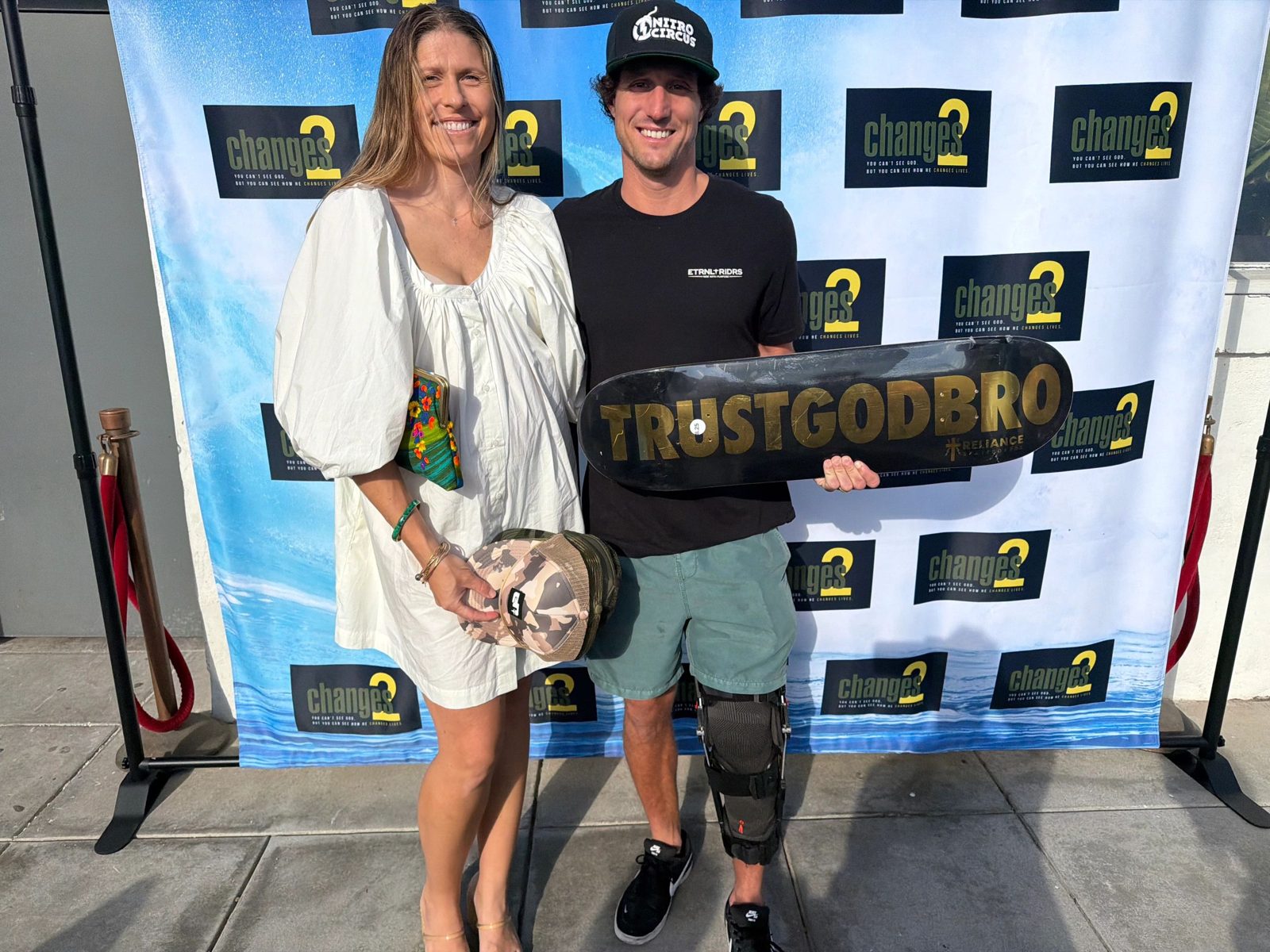 Guests with the Trust God Bro skateboard at the premiere